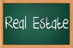 Picture of chalk board with large words reading Real Estate on it